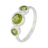 Lily sterling silver green gemstone trilogy ring with three bezel set peridot stones on polished band